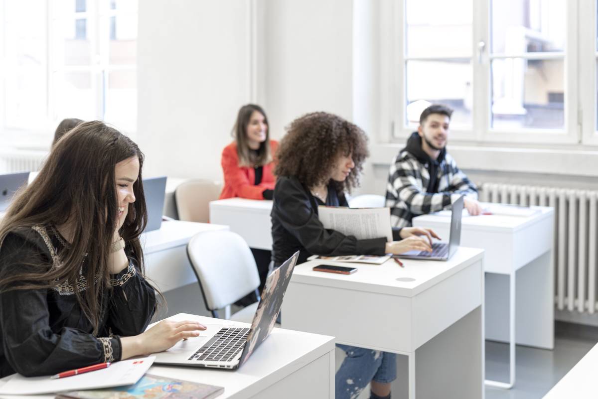 students sat at desks with laptops