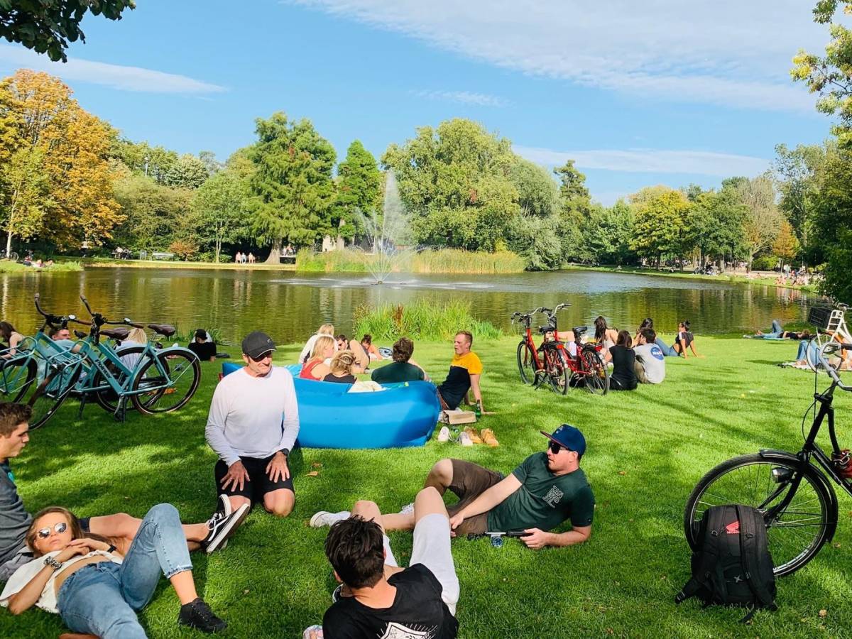 Students sit in a park in Amsterdam.