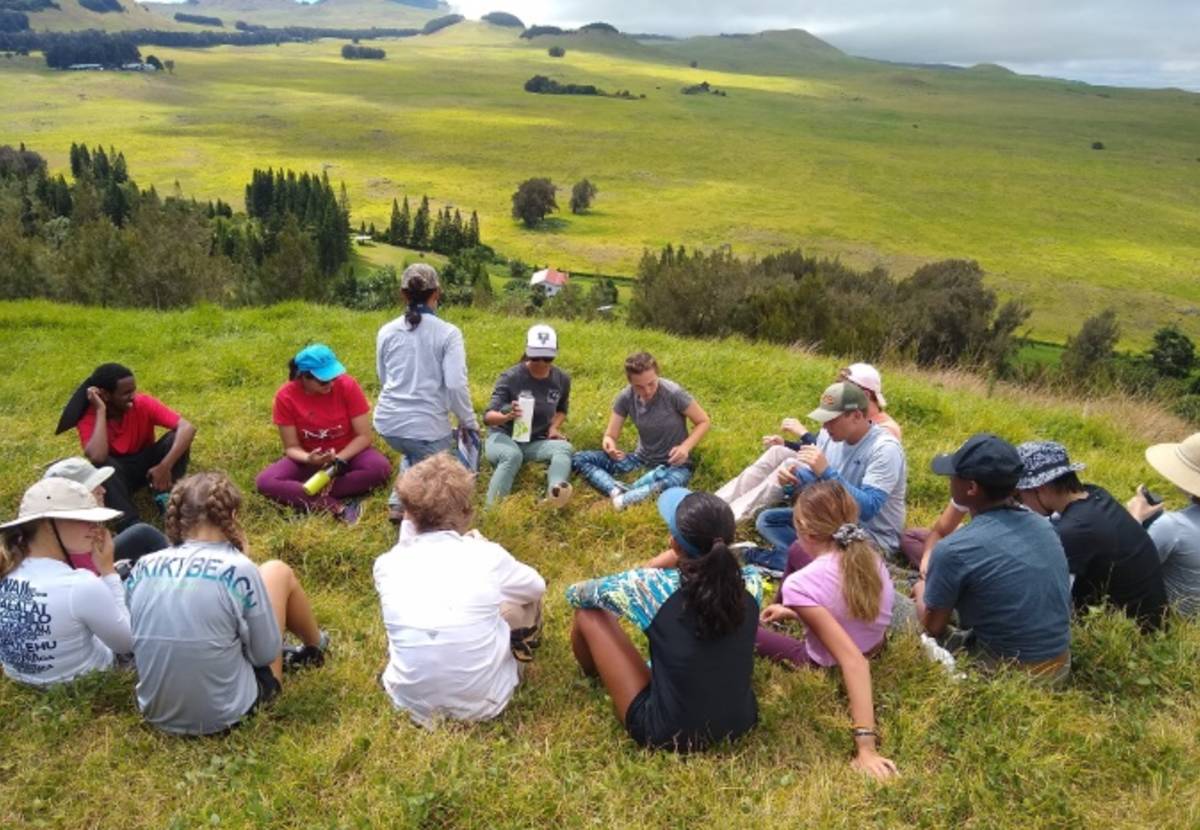 students sitting in circle in hawaii