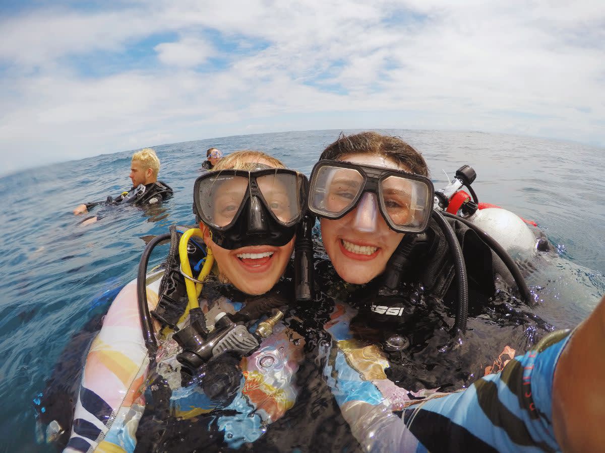 Students smiling and SCUBA diving