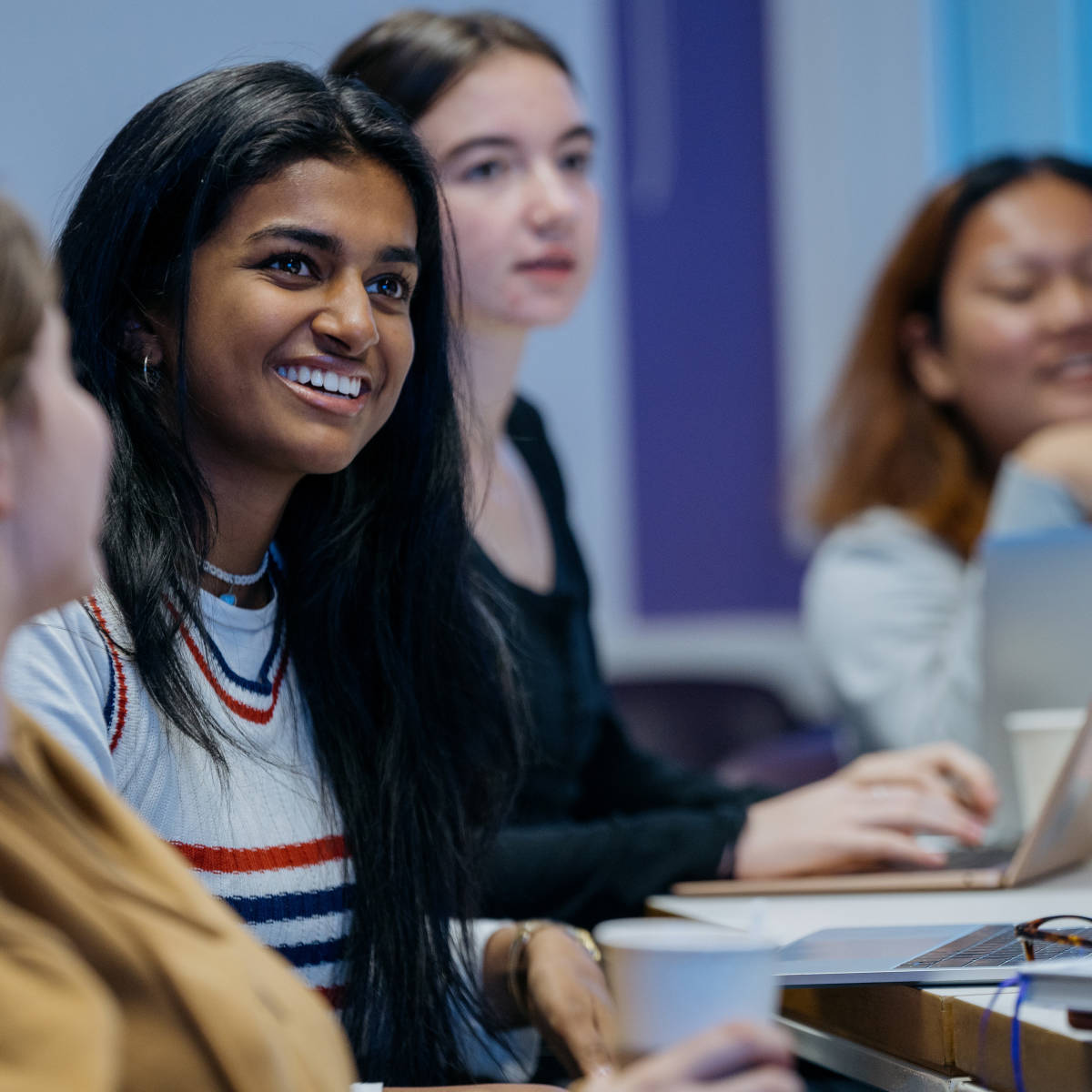 Students smiling in the classroom. 