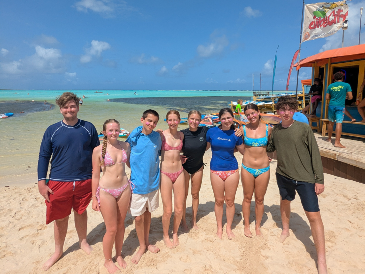 students stand on windsurfing beach in Bonaire