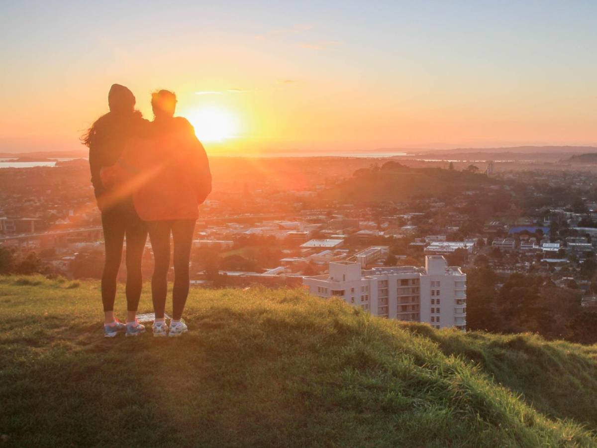 Students standing on top of a hill, looking out over Aotearoa's landscape.