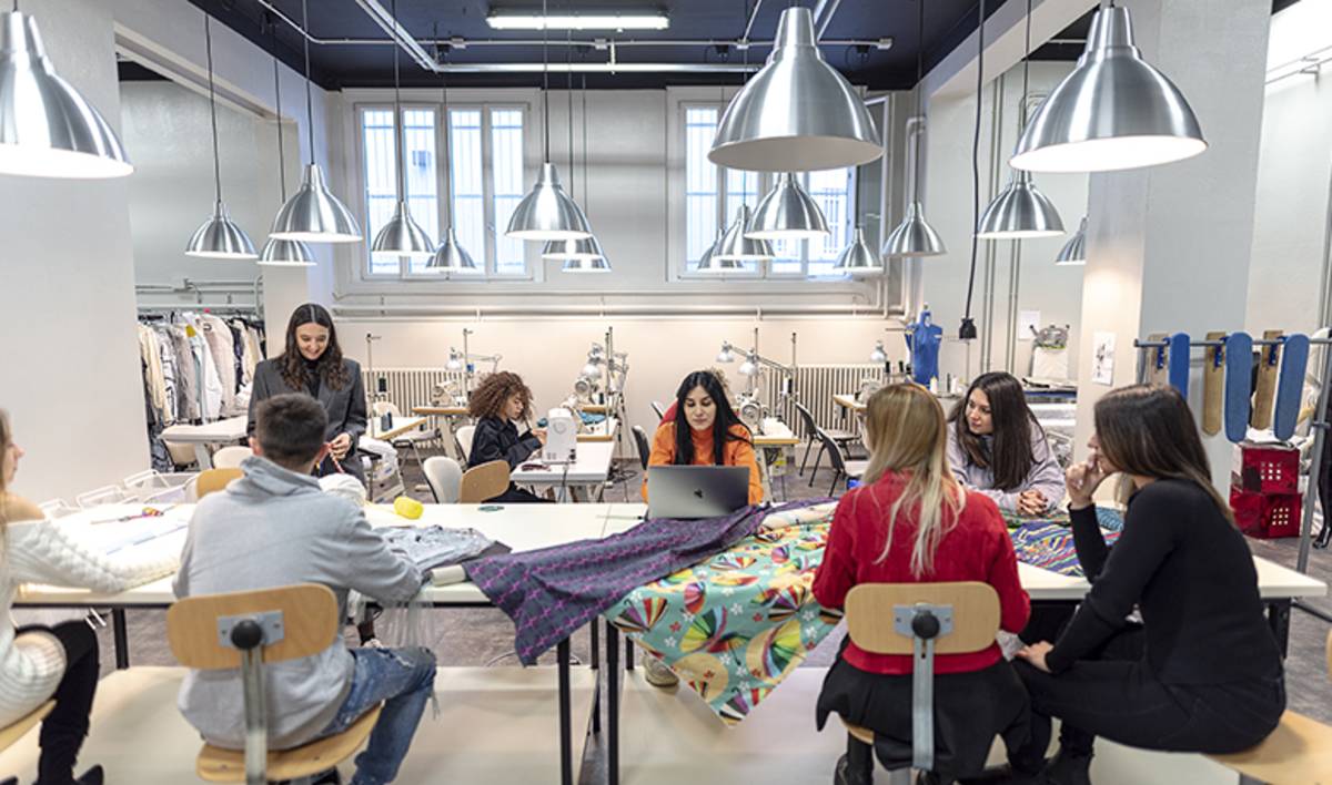 Students studying fashion design in a lab