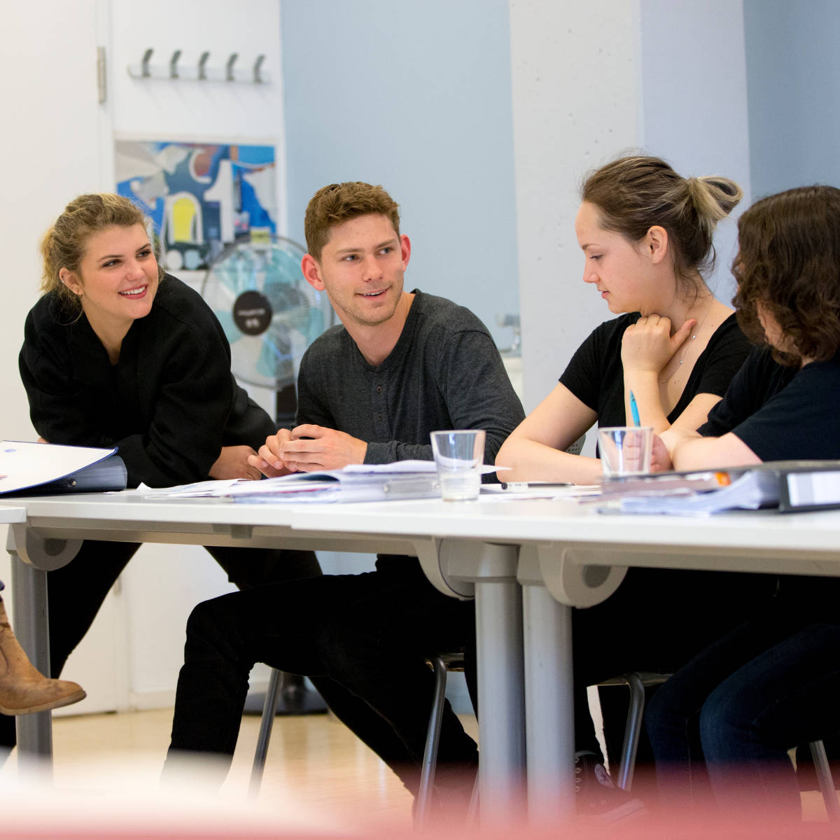 Students talking in a classroom.