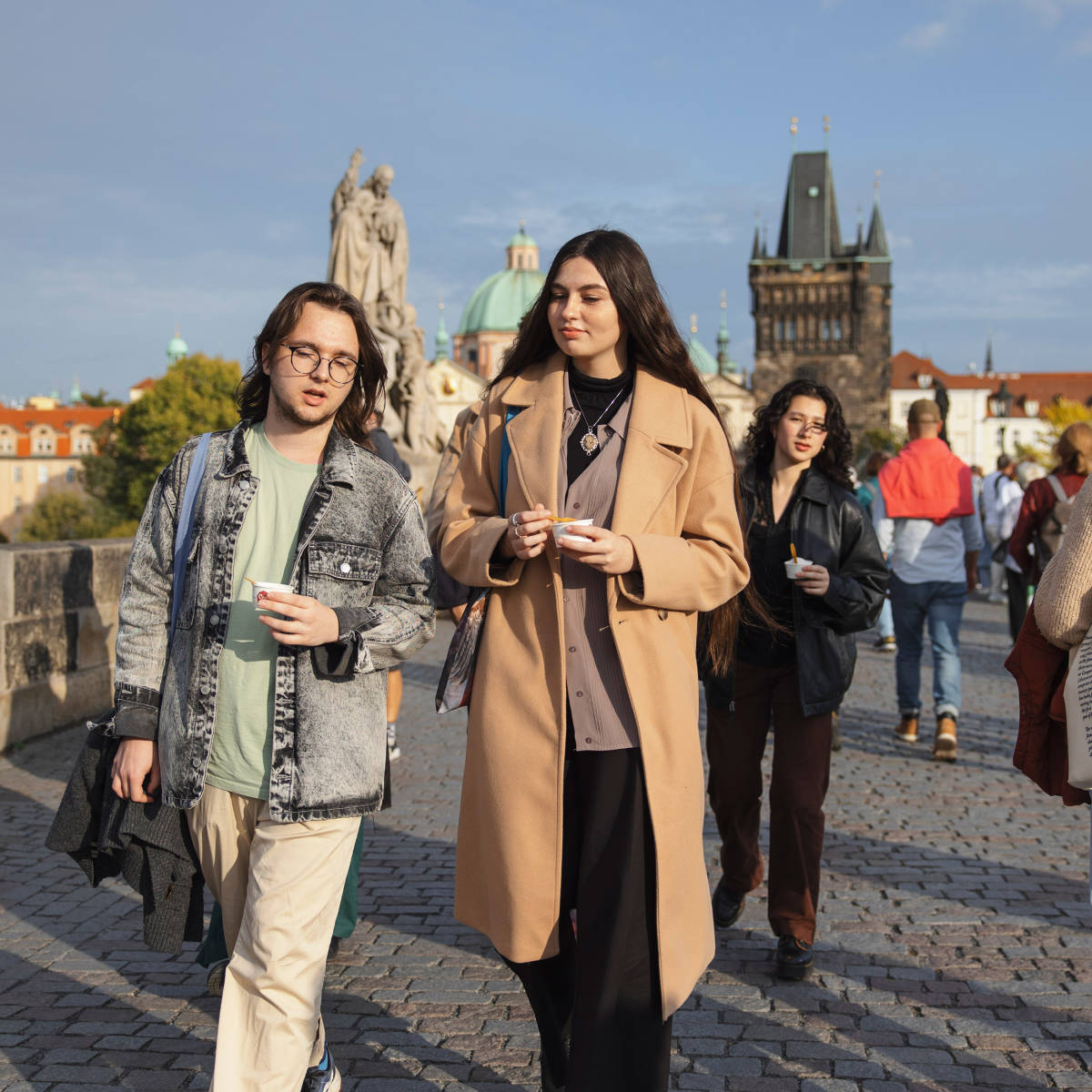 Students walk on bridge in Prague.