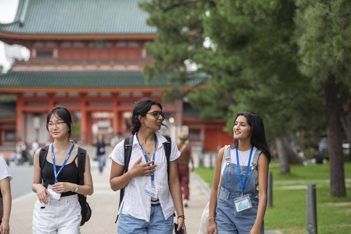 Students walking near temple in Japan