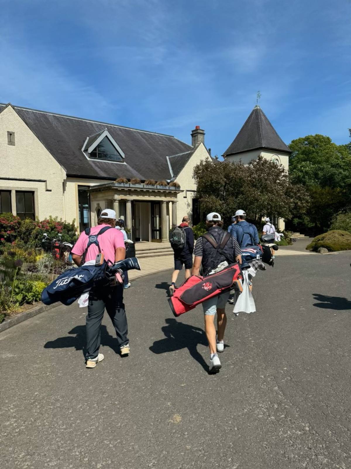 Students walking with golf bags to classroom in Scotland