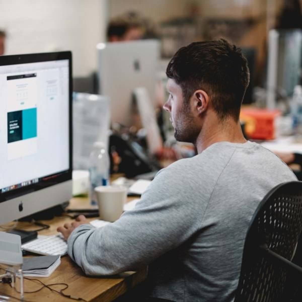 Male Intern infront of computer