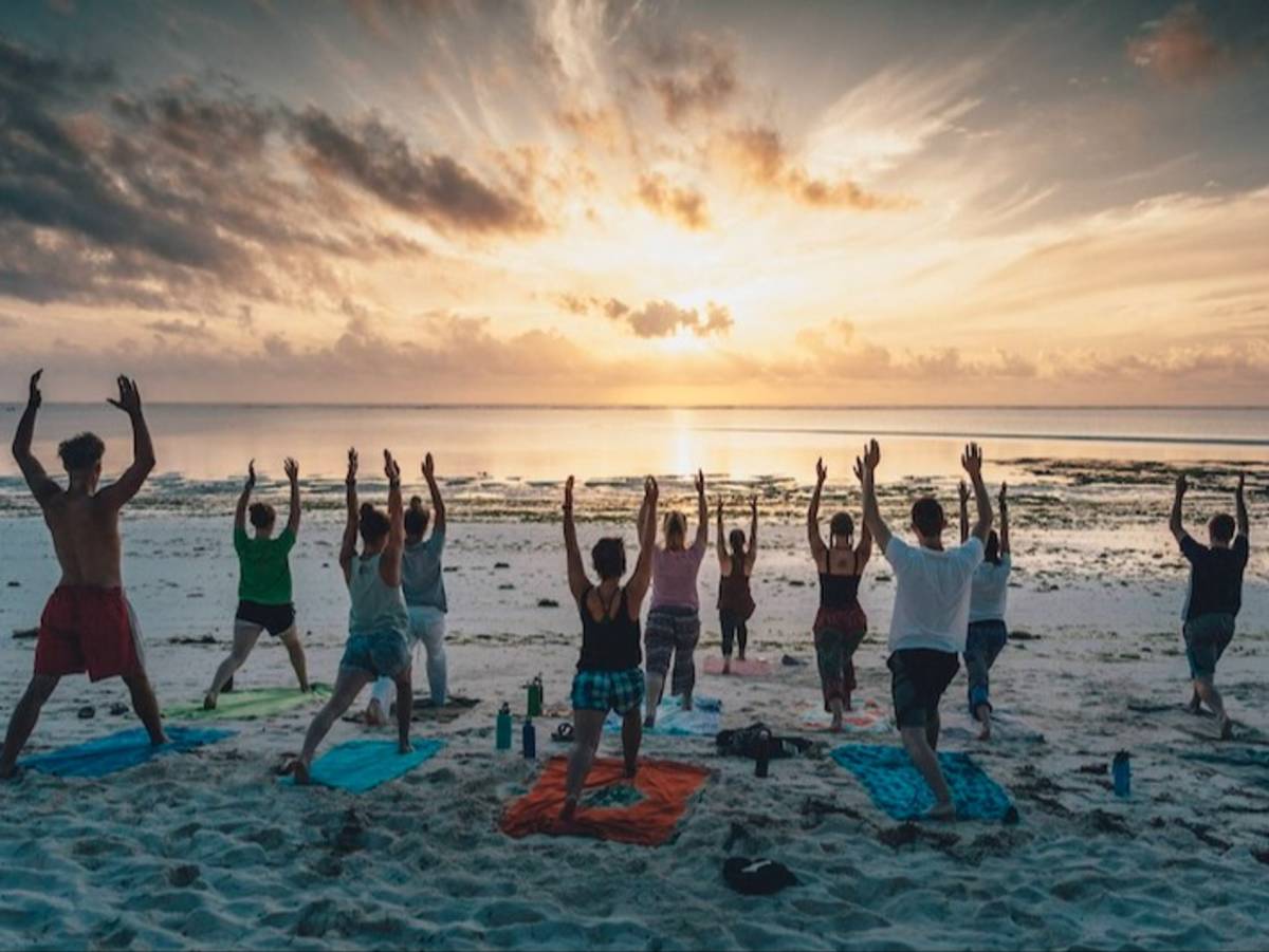 Sunrise yoga on local Tanzanian beach