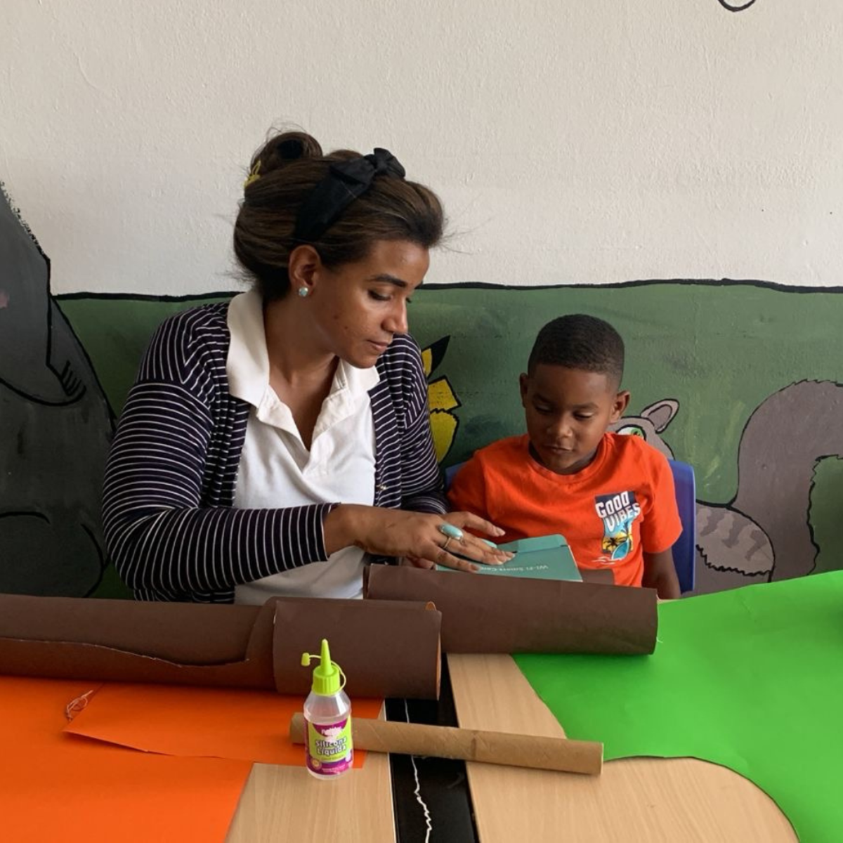 teacher helping student with art