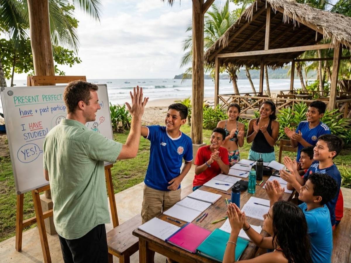 Teacher high-fiving student by whiteboard in beach pavilion class