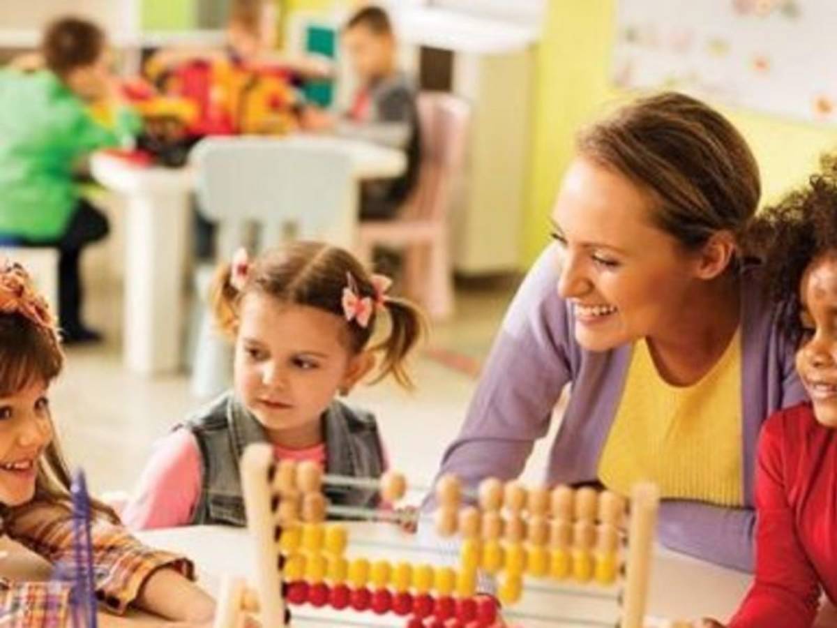 teacher playing with her students