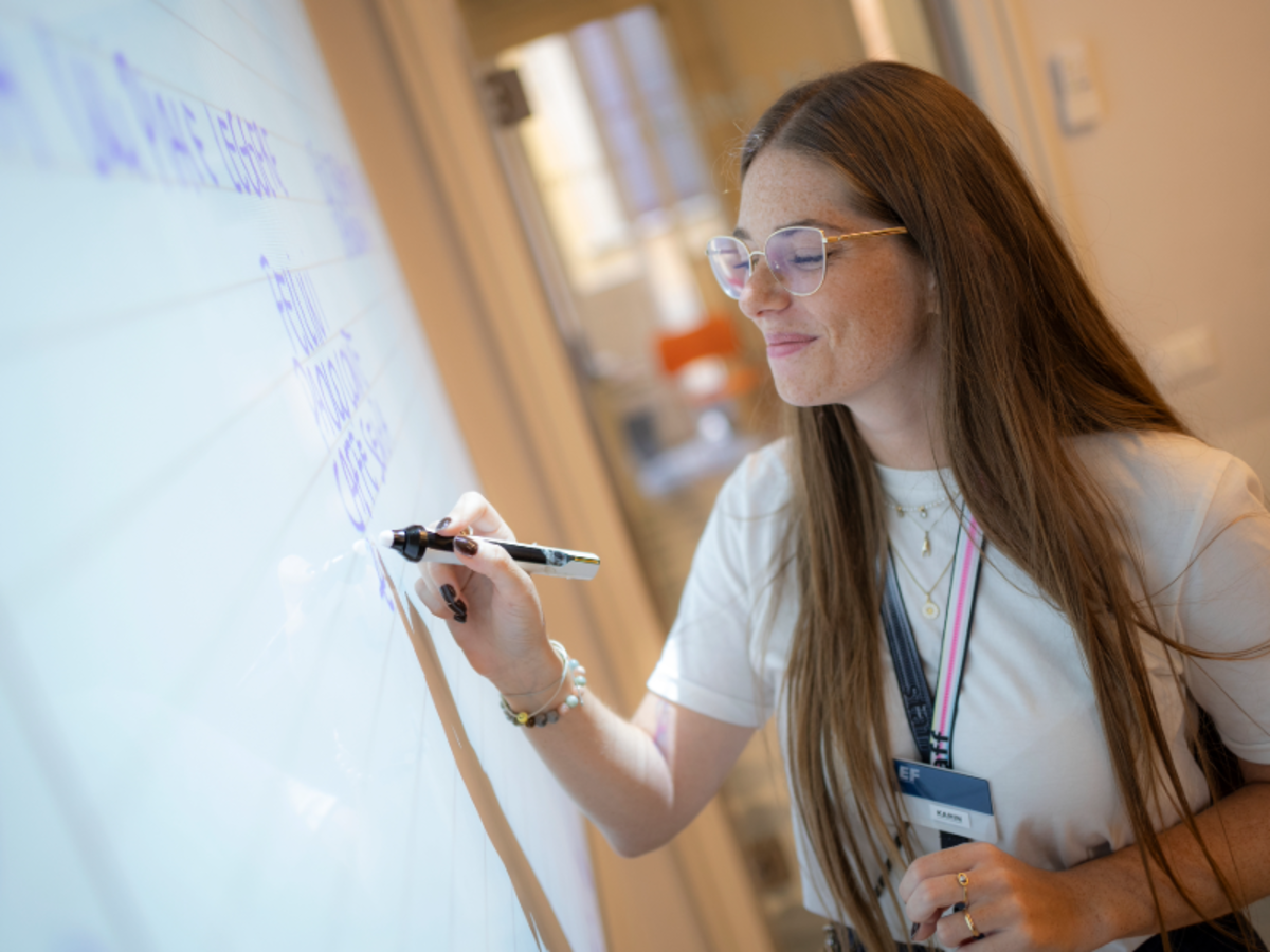 Teacher writing on an interactive whiteboard during an Italian language class at EF Rome.