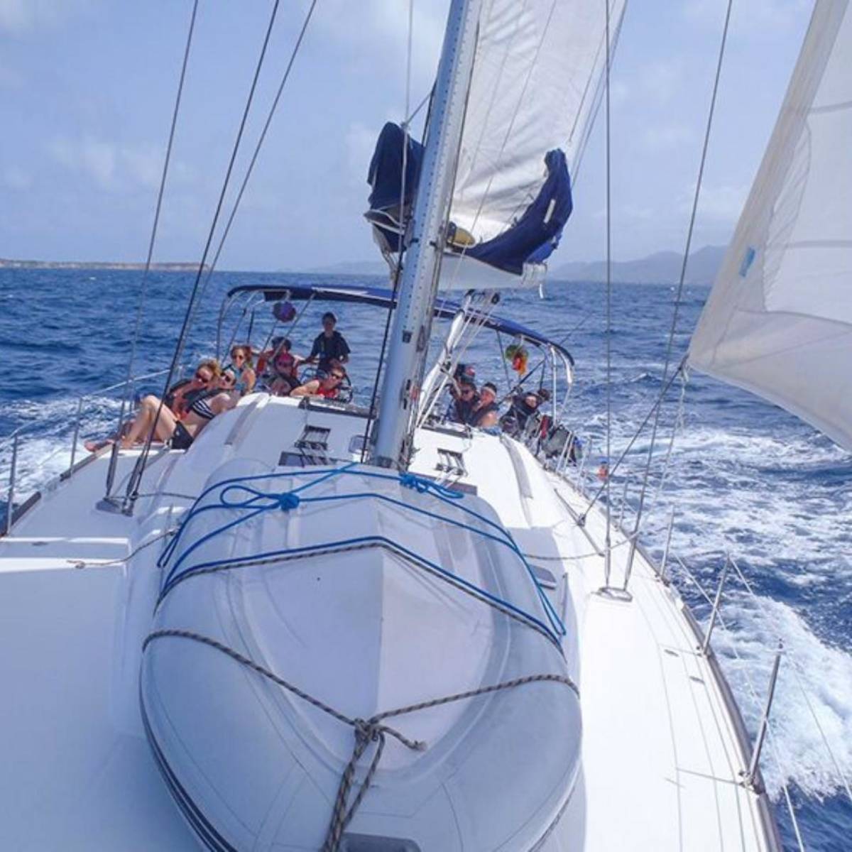 Teens sailing a monohull