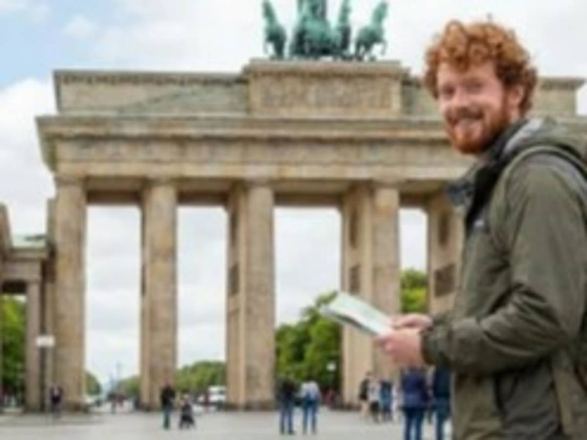 TEFL student visiting Berlin's Brandenburg Gate while preparing for an international teaching career.