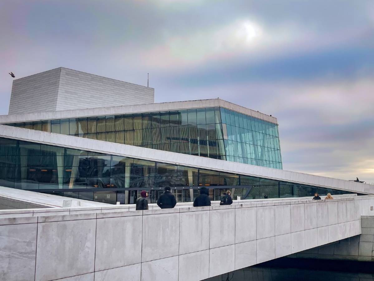 the Oslo Opera house with pink and purple sunset clouds in the sky