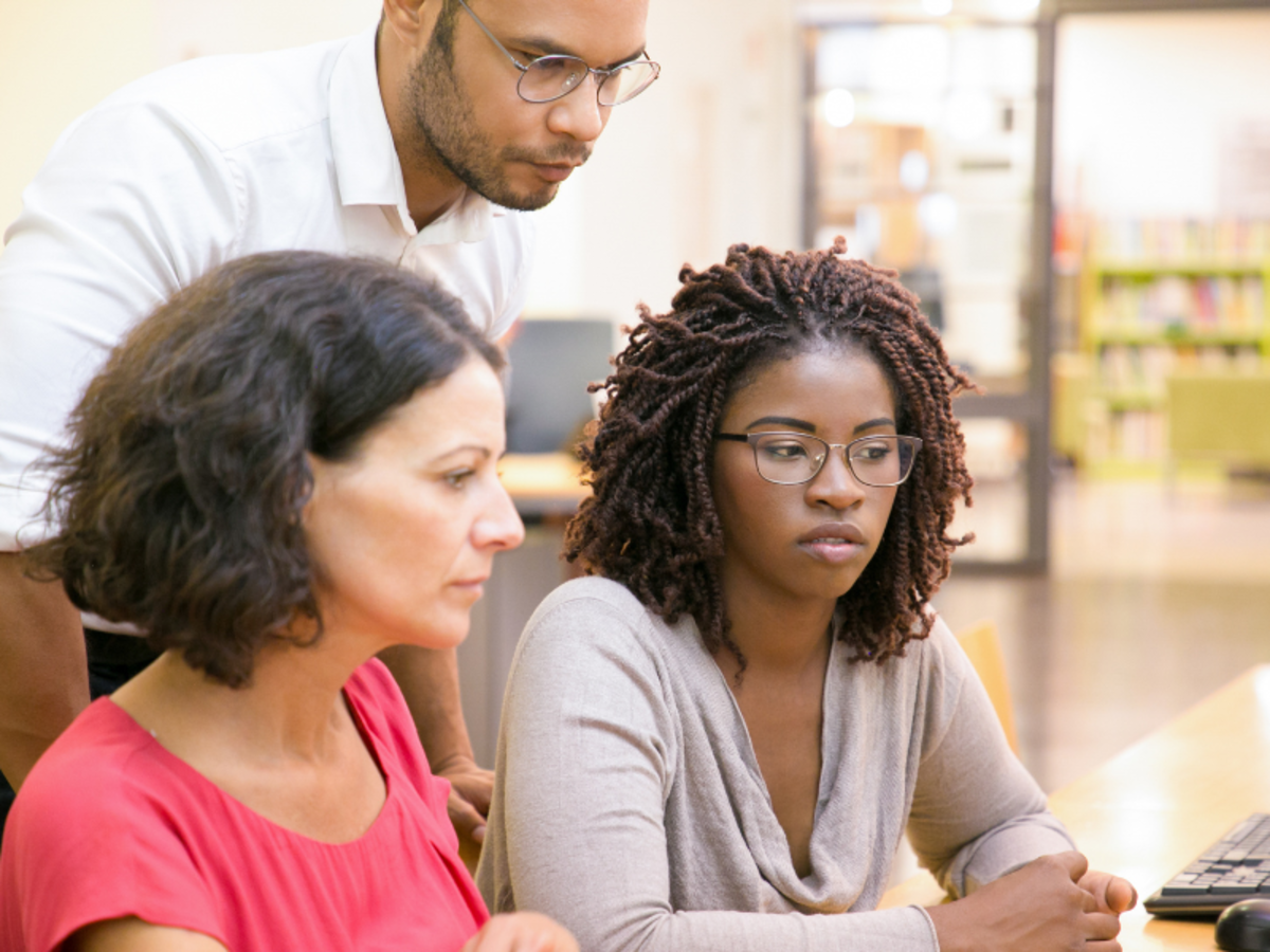 This image shows a group of adults collaborating on a project