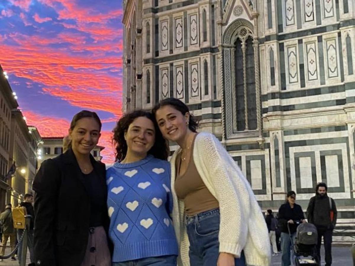 Three students stand at the Duomo at Sunset in Florence, Italy.