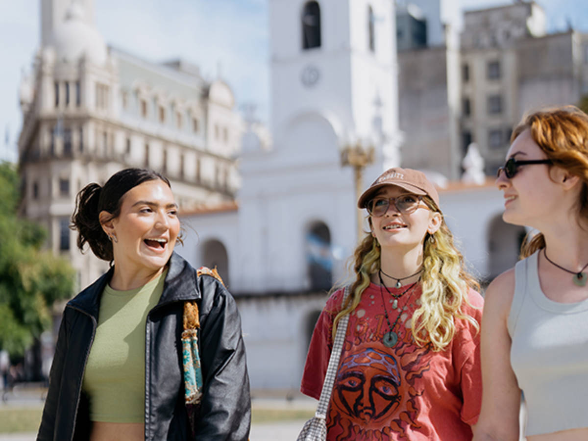 Three students walking and talking
