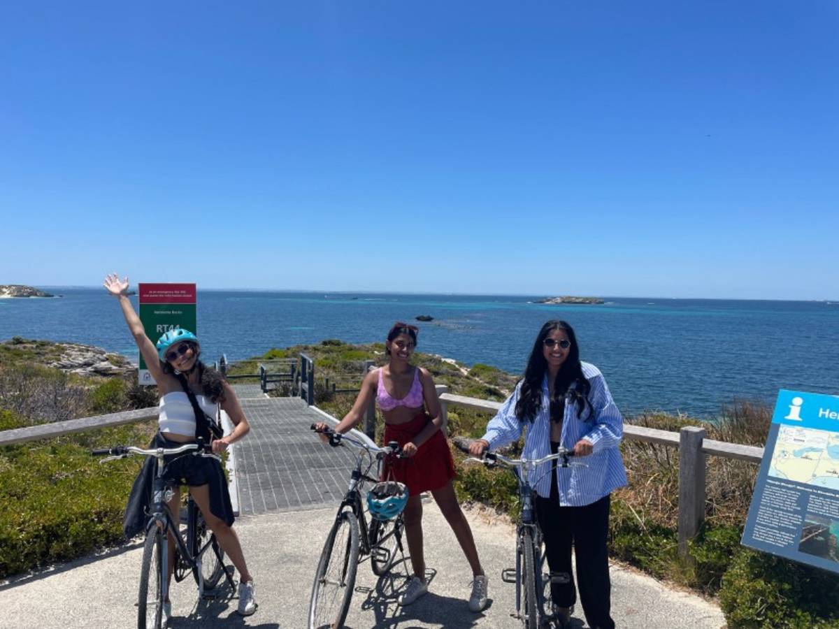Three woman with bikes by the ocean