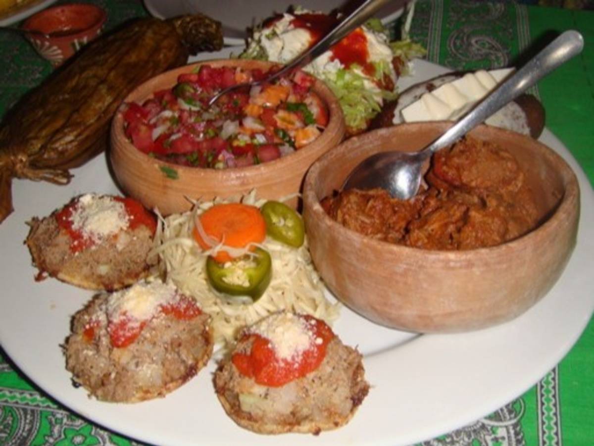 Traditional Mexican dishes including tacos, salsa, and fresh ingredients served on a table in Oaxaca, Mexico.