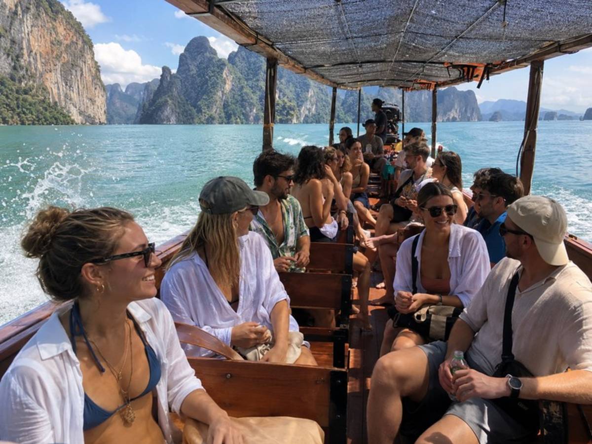 Travellers cruising between limestone islands in Thailand