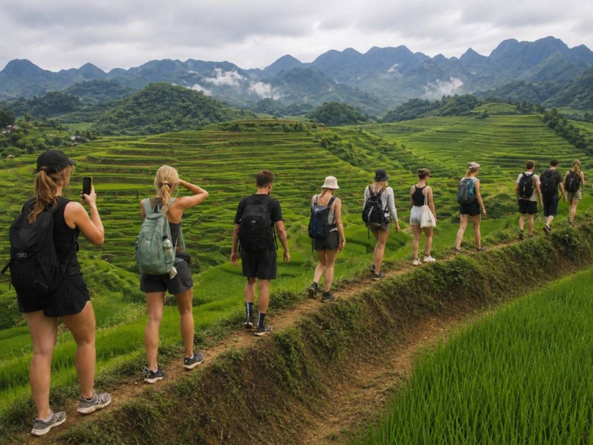 Travellers hiking through mountain rice terraces in Vietnam