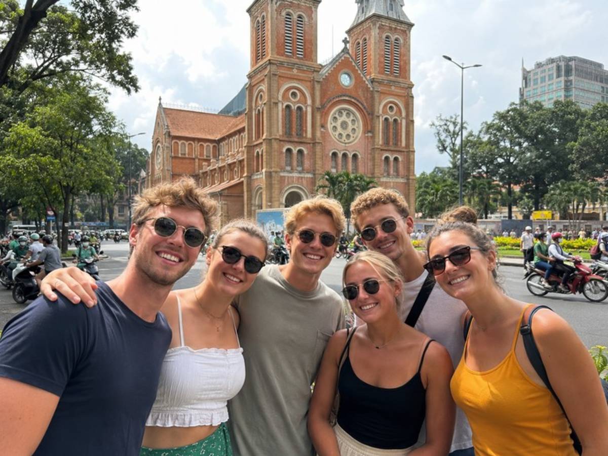 Travellers outside Notre Dame Cathedral in Ho Chi Minh City