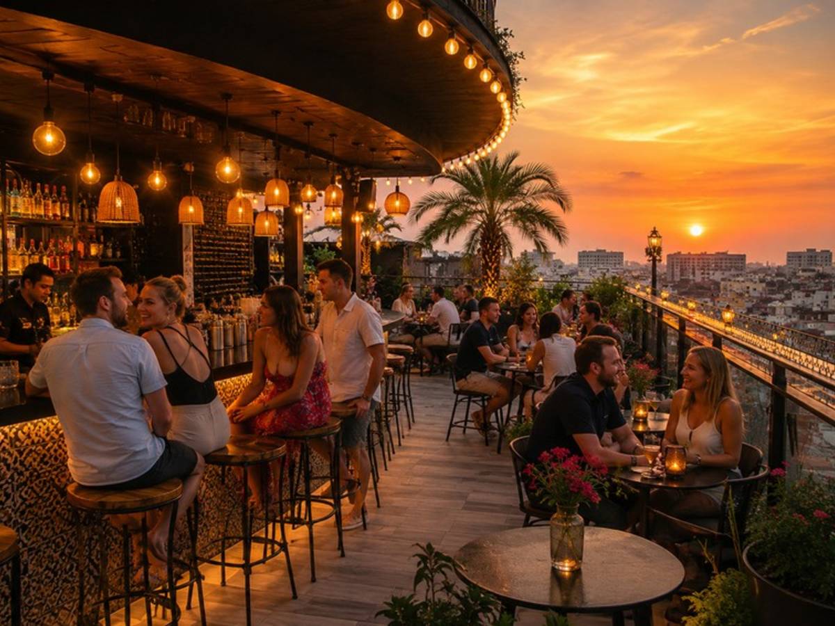 Travellers socialising at a Hanoi rooftop bar during sunset