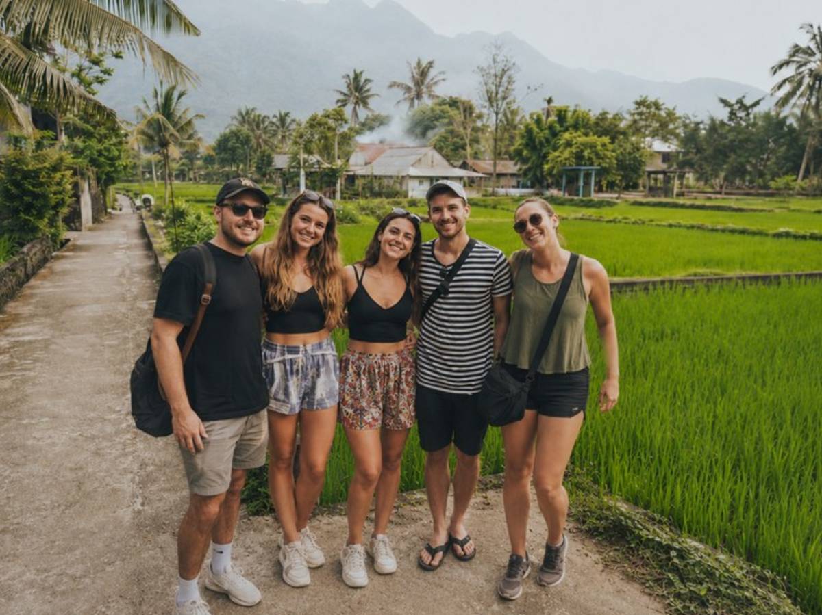 Travellers visiting green rice fields in rural Vietnam