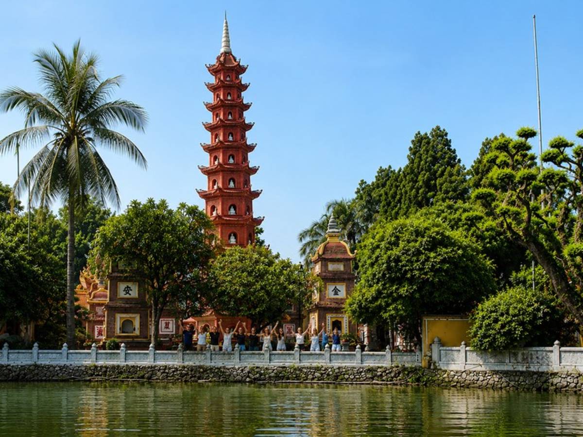 Travellers visiting Tran Quoc Pagoda beside West Lake in Hanoi