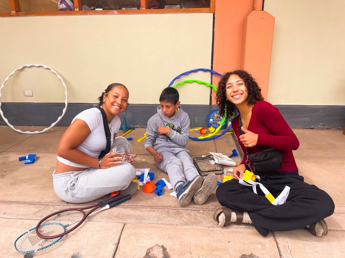 Two Female Volunteers Assisting a Child in Guatemala