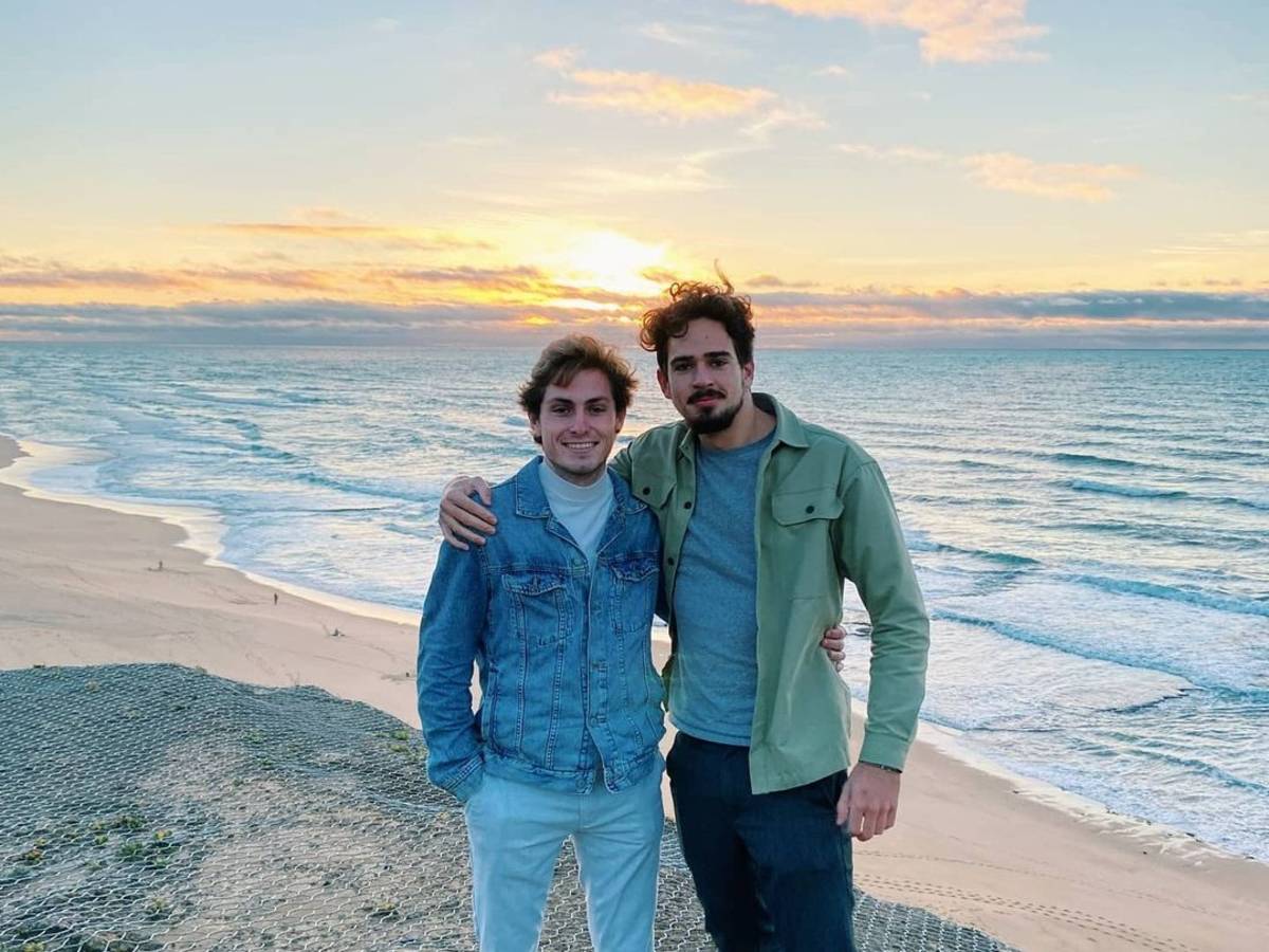 two friends at a cliff during sunset in Portugal