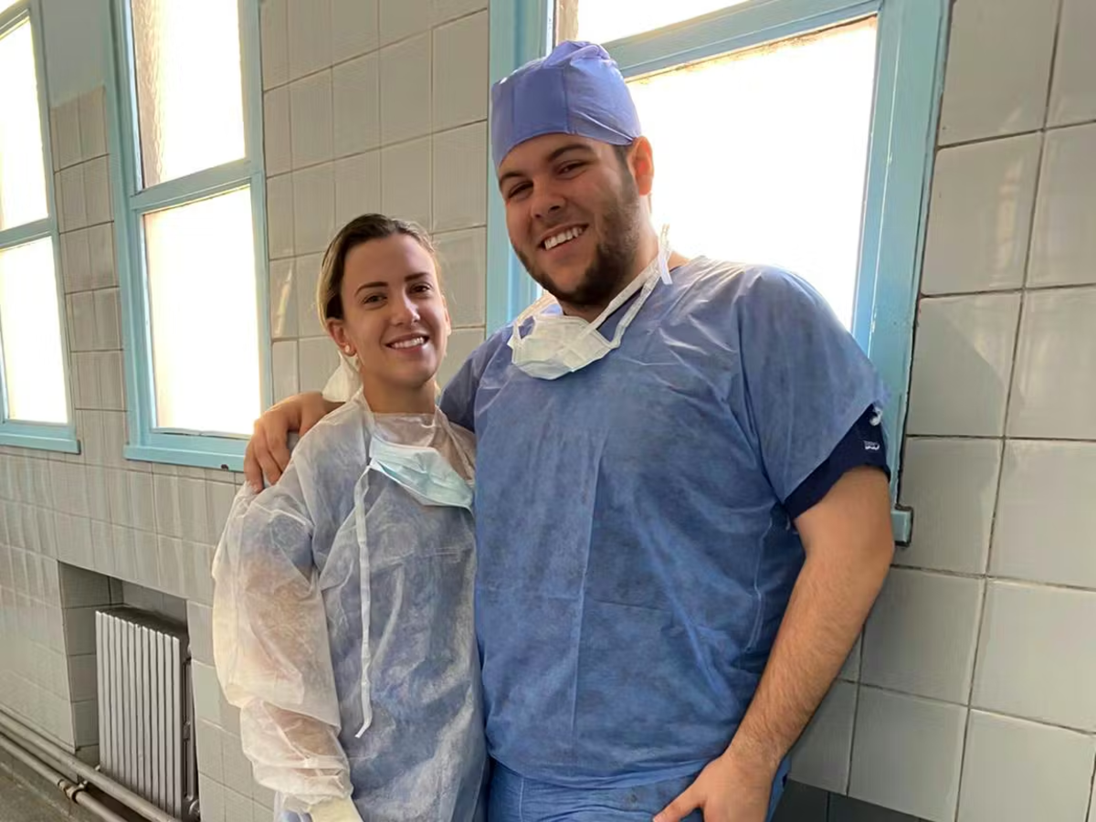 Two IVHQ Volunteers in Scrubs taking a photo