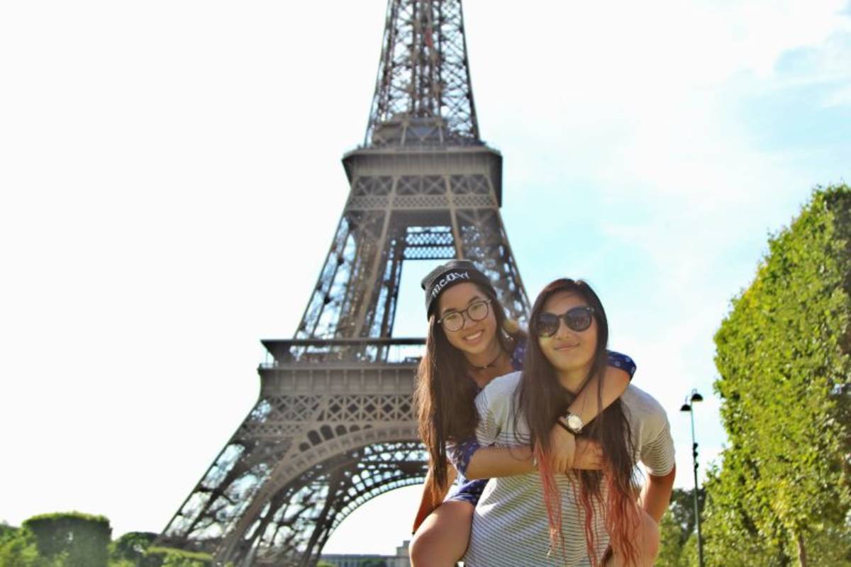 two students posing in front of eiffel tower