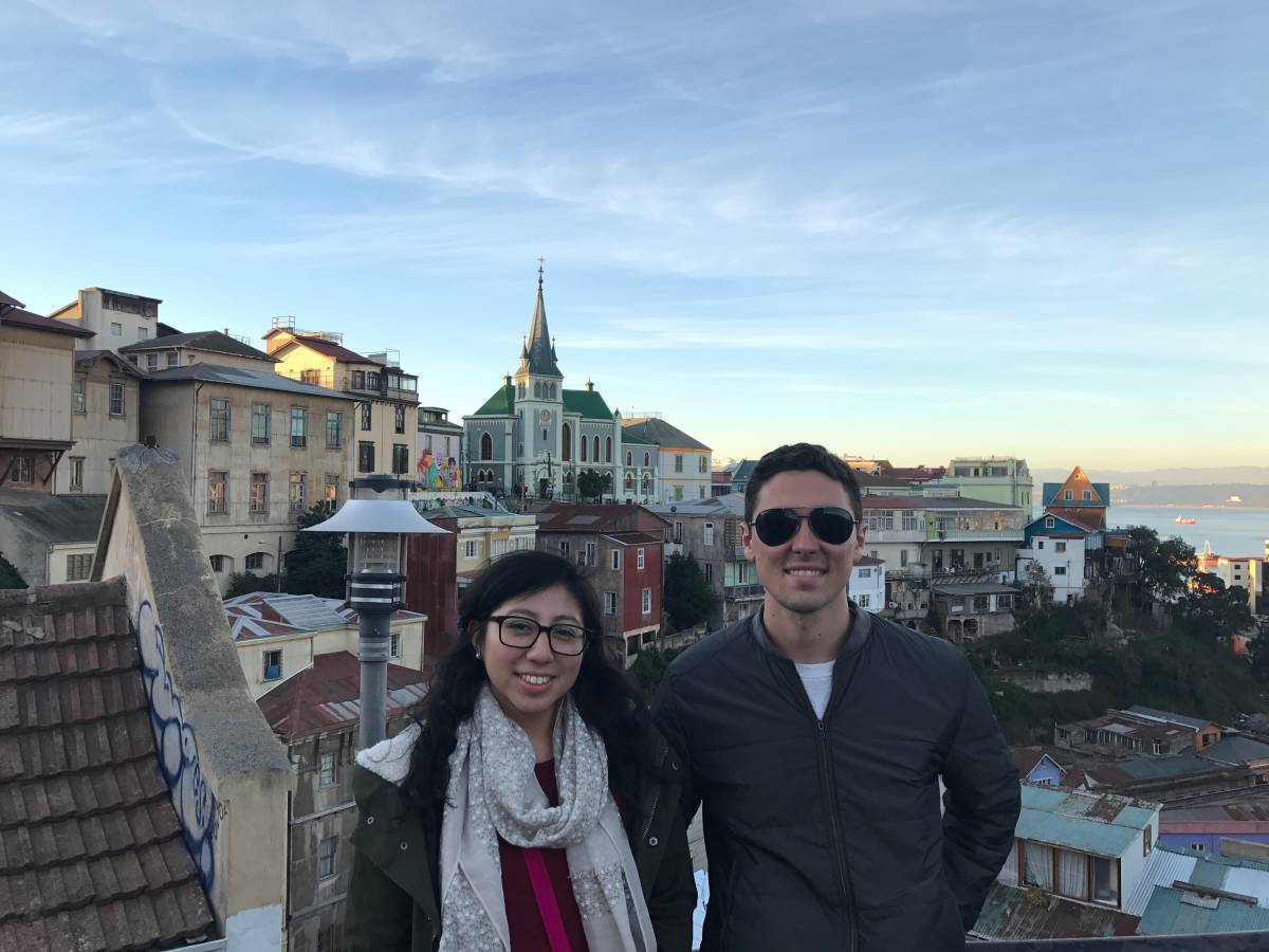 Two students smiling and chatting while teaching English together in Chile, forming a new friendship.