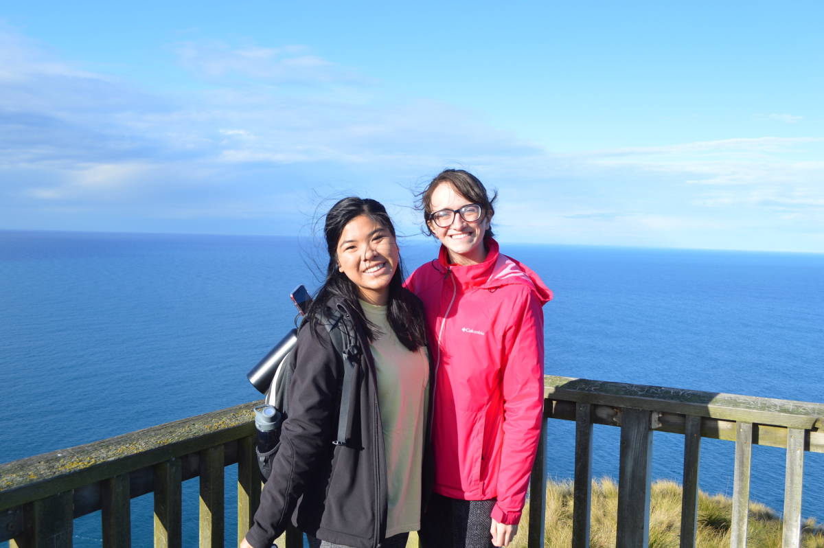 Two women overlooking ocean view.