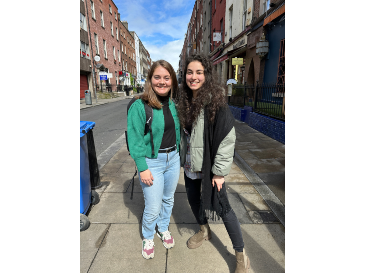 two women standing together on a city street in Ireland
