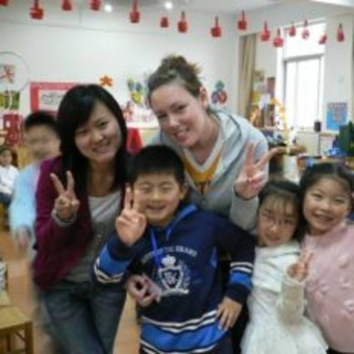 Two women TEFL teachers posing with their children students