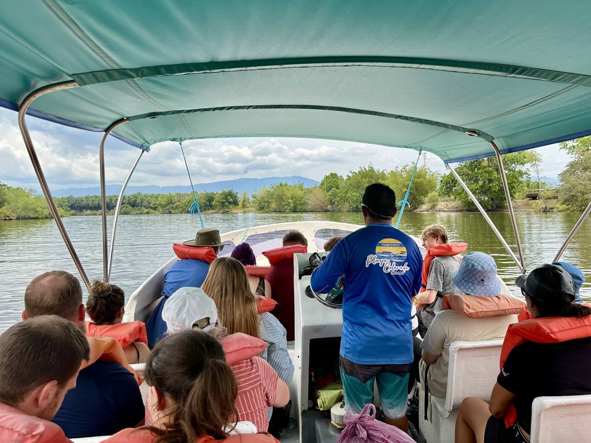 View looking out from inside of boot, to other passengers and views of the lagoon.