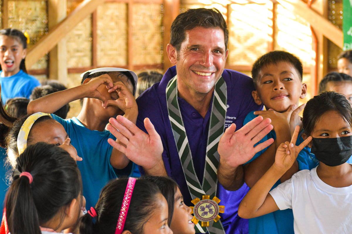 Volunteer celebrating with students