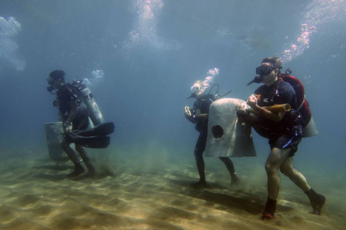Volunteer divers creating artificial reef