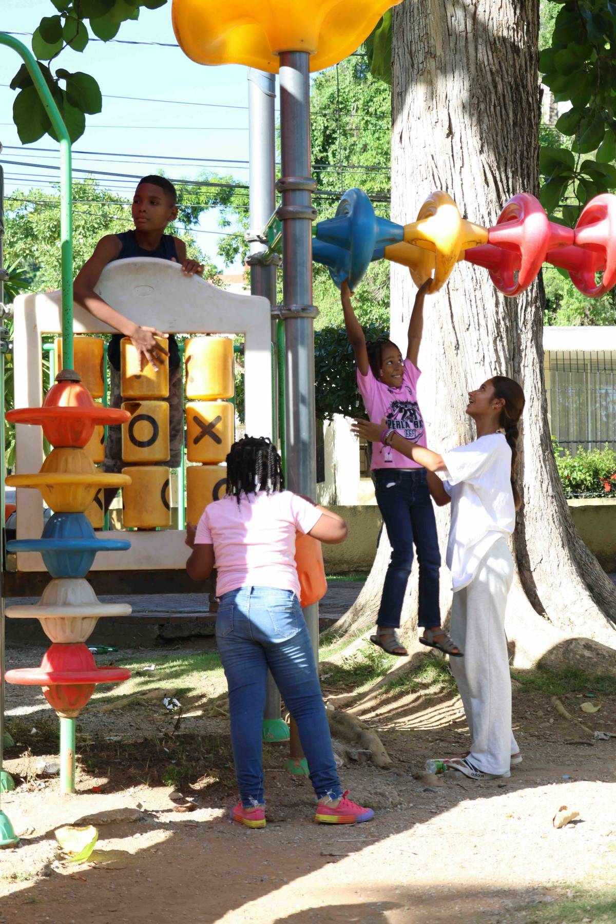 volunteer playing with children on the playground