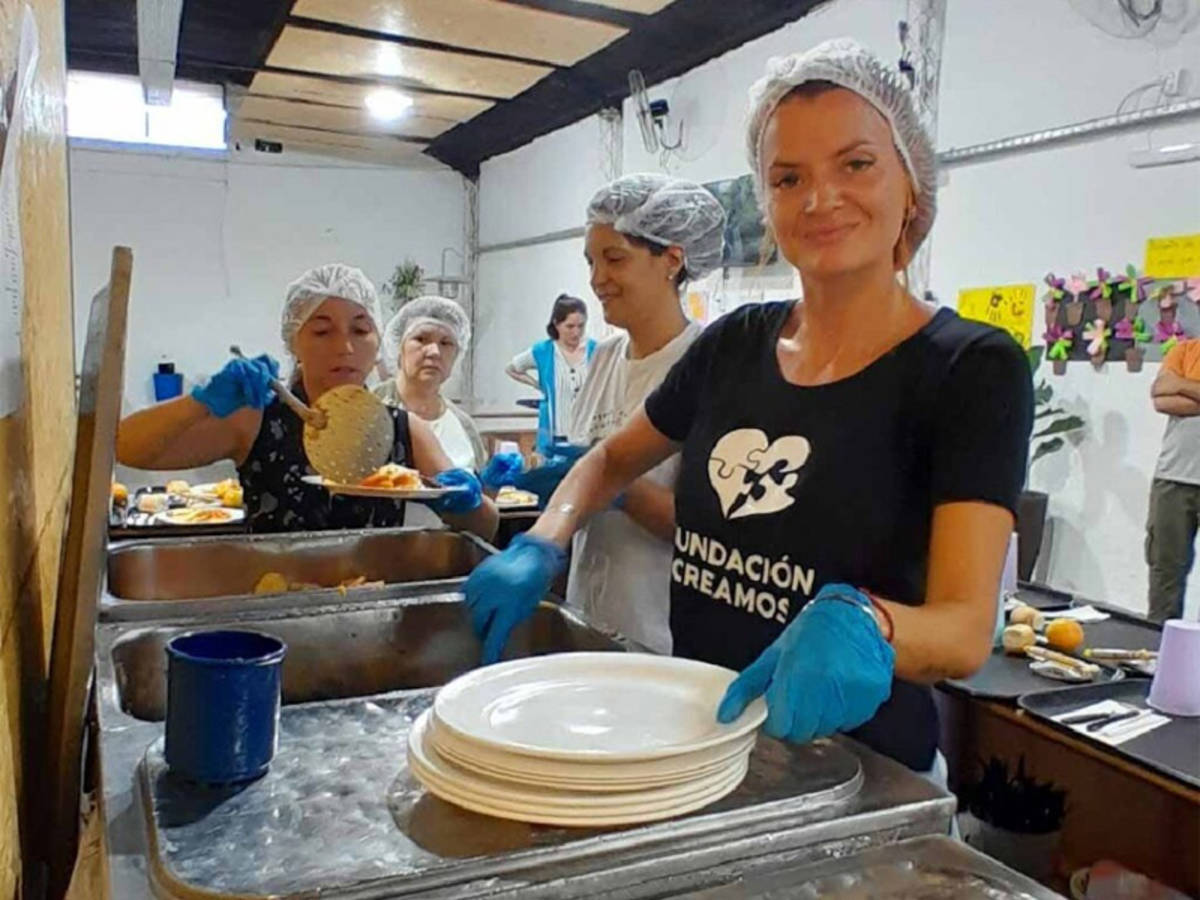 Volunteer serving food to homeless people