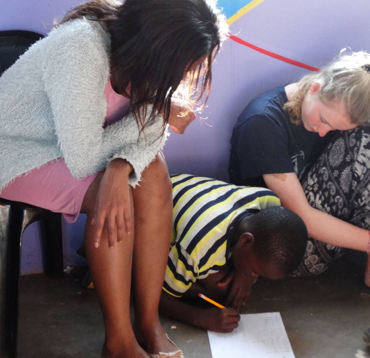 Volunteer helping child with homework