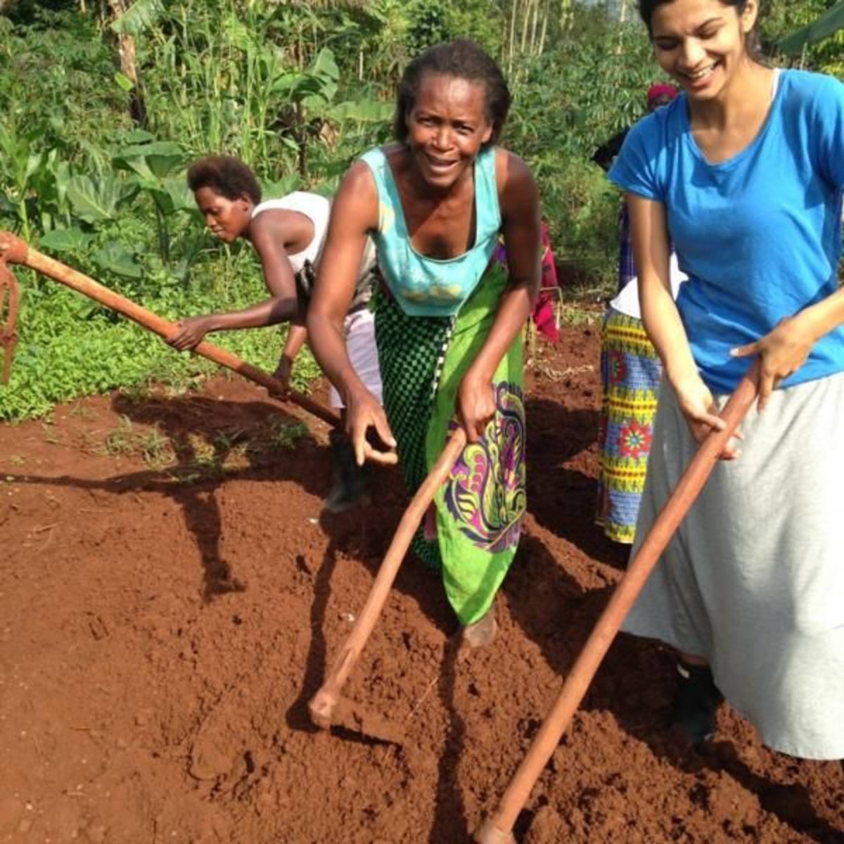 Volunteer clearing land on a communal farm in Uganda
