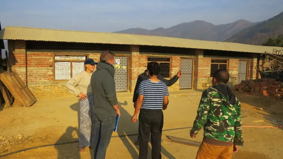 Volunteers in Nepal doing construction work meetings with locals