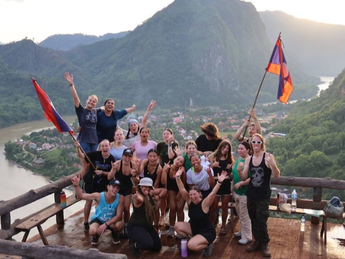 Volunteers posing at scenic viewpoint in local Laos village
