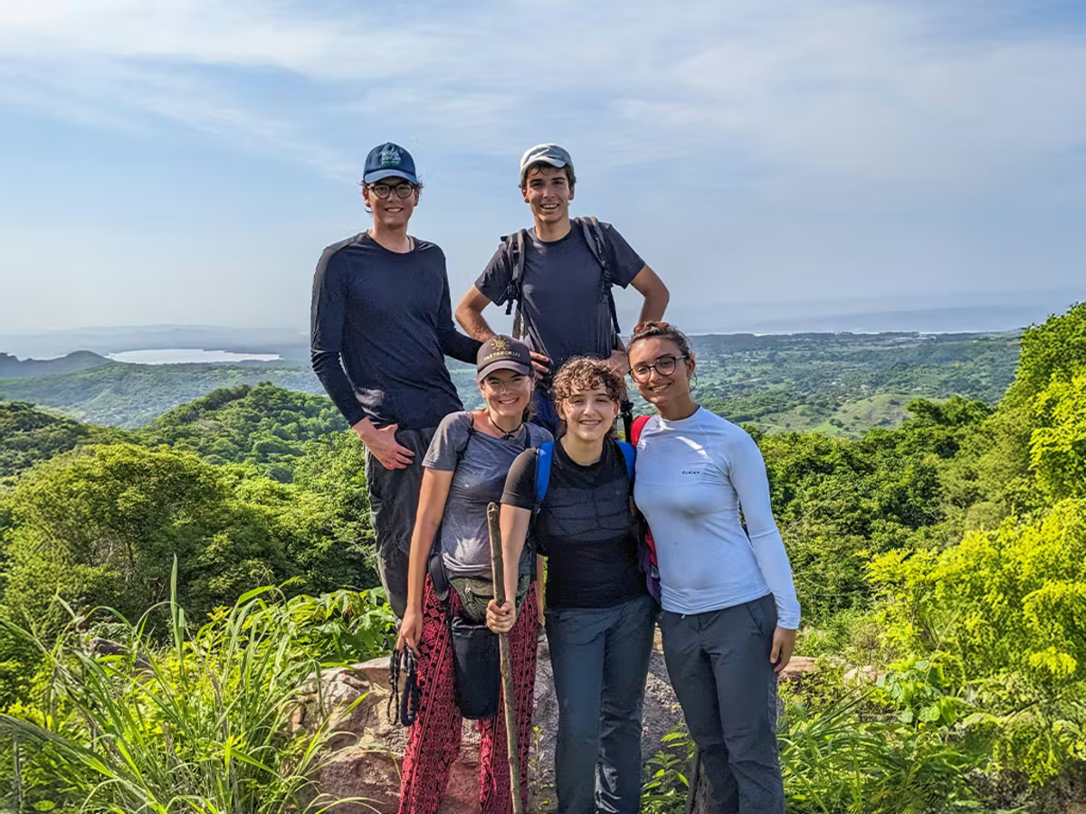 Volunteers Standing Together on a Mountain